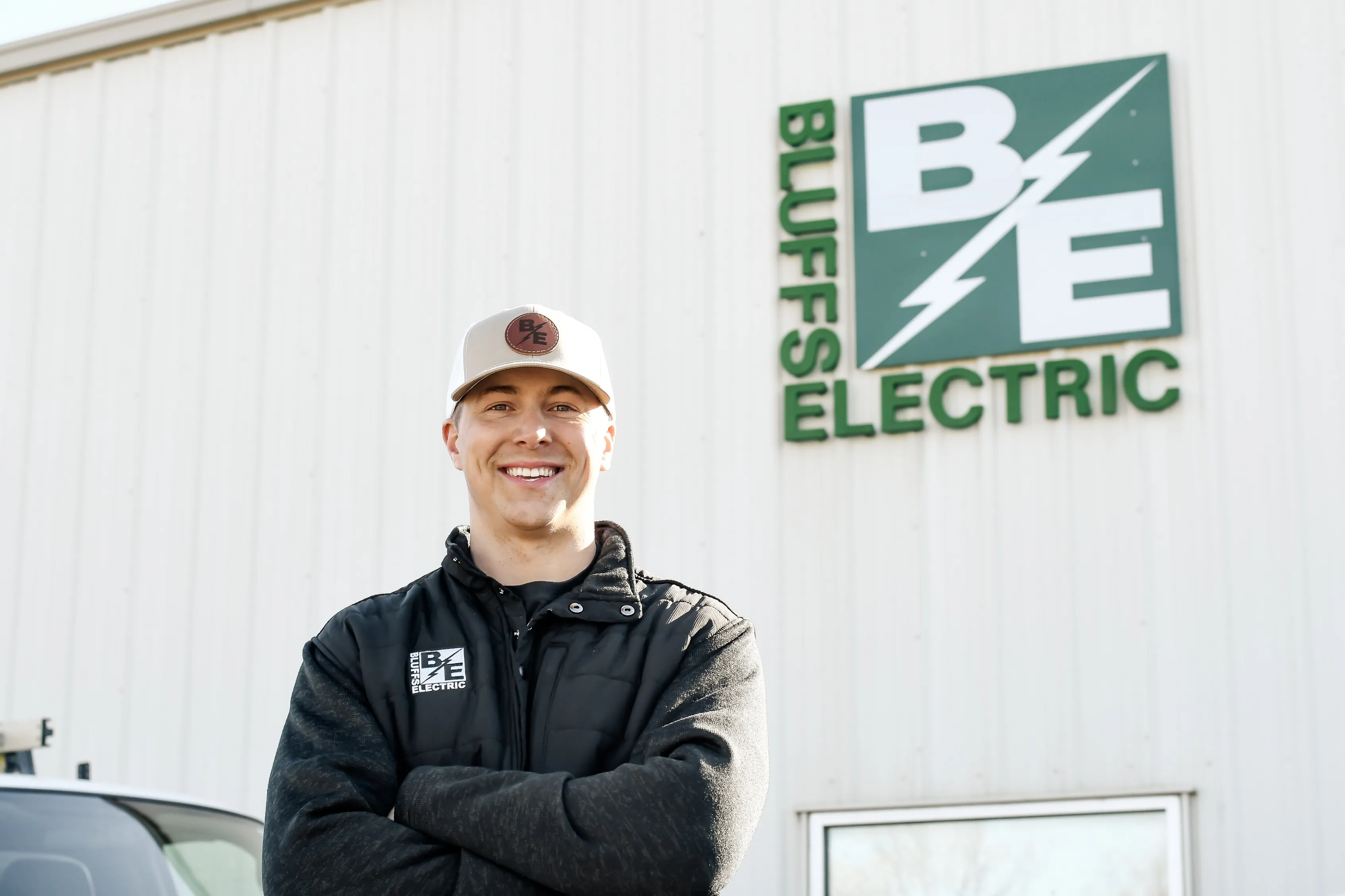 Bluffs Electric technician outside the shop
