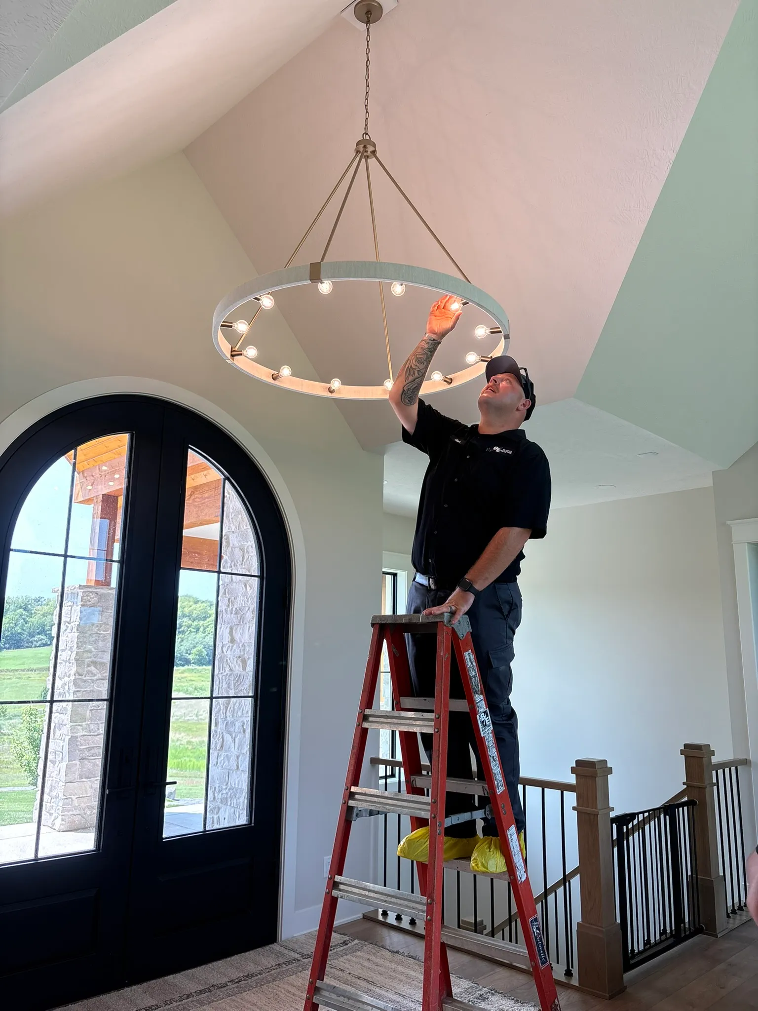 Before and after comparison of a lighting upgrade in a Council Bluffs living room