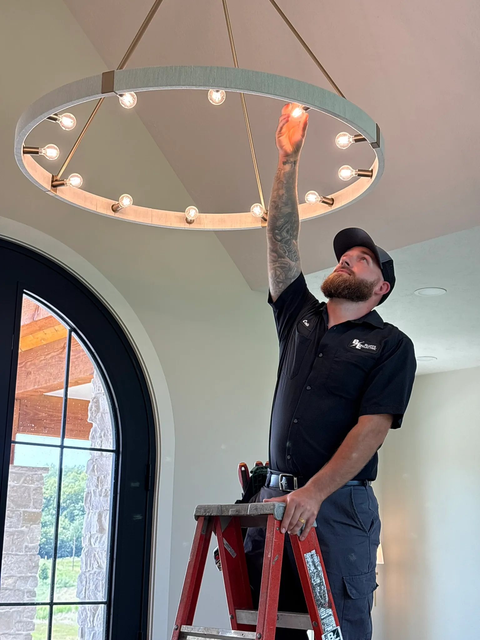 Modern kitchen lighting installation with recessed lights and pendant fixtures