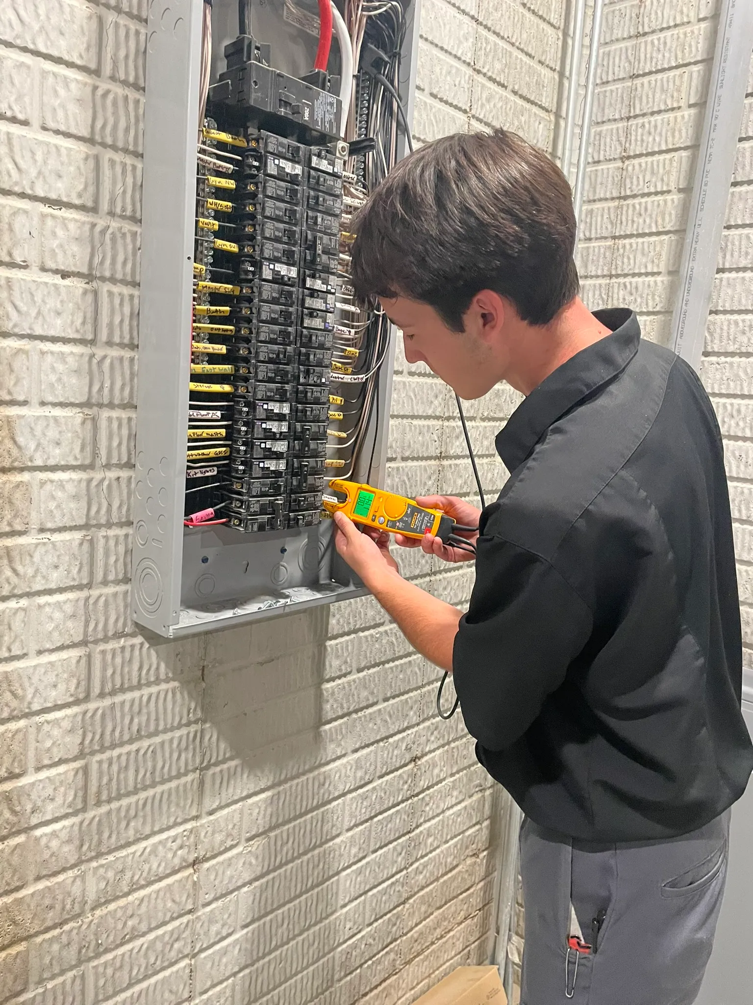 Bluffs Electric technician inspecting an electrical panel during a home assessment